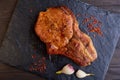 Delicious and juicy steak on a stone table surrounded by spices