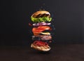 Delicious, juicy burger layers over a dark background