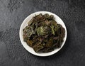 A delicious Kale chips, snack on white plate. Healthy vegetable food. Royalty Free Stock Photo