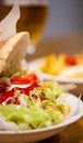 Delicious Kebab Sandwich with Fried Potatoes and a Refreshing Beer. Royalty Free Stock Photo