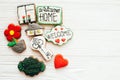 Delicious key, house, plant,window,heart and welcome sign cookies on white wood, flat lay with space for text. Dream home concept