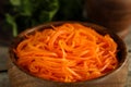 Delicious Korean carrot salad in wooden bowl, closeup