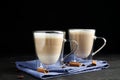 Delicious latte macchiato, cinnamon and coffee beans on grey table against background Royalty Free Stock Photo