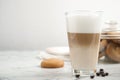 Delicious latte macchiato, cookies and coffee beans on white marble table, space for text Royalty Free Stock Photo