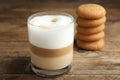 Delicious latte macchiato and cookies on wooden table Royalty Free Stock Photo