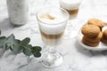 Delicious latte macchiato and tasty cookies on white marble table Royalty Free Stock Photo