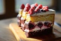Delicious layered berry cake on a wooden table