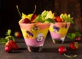 Delicious layered berry and fruit smoothie with edible flowers. Healthy dessert. Clean eating
