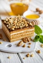 Delicious layered honey cake with chocolate and walnut topping