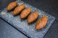 Delicious Lebanese food, kibbeh kibe on black slate stone and granite background