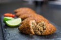 Delicious Lebanese food, kibbeh kibe on black slate stone and granite background