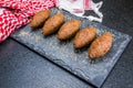 Delicious Lebanese food, kibbeh kibe on black slate stone and granite background with traditional keffyeh
