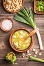 Delicious leek soup in wooden bowl