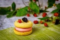 Delicious lemon cookie with pink cream and fresh blackberry Royalty Free Stock Photo