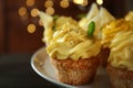 Delicious lemon cupcakes on dessert stand, closeup