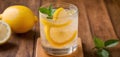 Delicious lemonade in a glass. Citrus fresh lemonade in glass on a table with lemons and mint