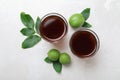 Delicious liqueur and green walnuts on light table, flat lay Royalty Free Stock Photo