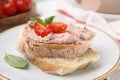 Delicious liverwurst sandwich with tomatoes and basil on table, closeup Royalty Free Stock Photo