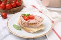 Delicious liverwurst sandwich with tomatoes and basil on white marble table Royalty Free Stock Photo