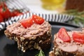 Delicious liverwurst sandwiches with tomatoes on table, closeup