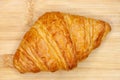 Delicious looking french croisant on a wooden background, top view minimal composition