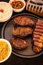 Delicious looking meal of grilled steak, a bowl of cooked rice, and several vegetables Royalty Free Stock Photo