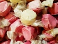 Delicious looking wrapped pink and yellow toffee candy - selective focus