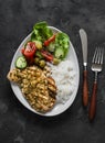Delicious lunch - lime, cilantro, garlic olive oil marinated grilled chicken breast, basmati rice and fresh vegetable salad on a Royalty Free Stock Photo
