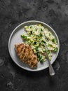 Delicious lunch - pasta orzo with zucchini and roasted chicken breast on a dark background, top view Royalty Free Stock Photo