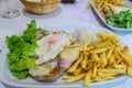 Delicious lunch of pork chop, fried potatoes and salad. Royalty Free Stock Photo