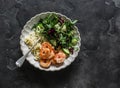 Delicious lunch - risoni pasta, shrimp and arugula, cucumber, celery salad on a dark background, top view Royalty Free Stock Photo