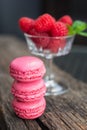 Delicious macarons raspberry flavored with a glass filled with f