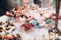 Delicious macaroons in glass bowl. candy bar at luxury wedding r