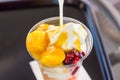 Delicious Mango ice cream sundae in plastic cup
