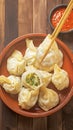 Delicious manti dumplings arranged beautifully on wooden background