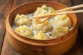 Delicious manti dumplings arranged beautifully on wooden background