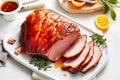 Delicious maple glazed gammon with appetizing crust sliced on white dish. Holiday meal for family dinner