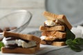 Delicious marshmallow sandwich with bread and chocolate on white wooden table, closeup