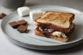 Delicious marshmallow sandwiches with bread and chocolate on wooden table, closeup