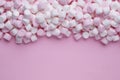 Delicious marshmallows on pink background, flat lay. Space for text