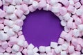 Delicious marshmallows on purple background, flat lay. Space for text