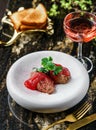 Delicious meat pate foie gras on plate with berry sauce, sprouts and toasts on marble background with drinks. Healthy food, top