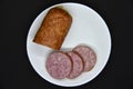 Delicious meat sausage on a white plate. Sliced ham. Slices of meat Royalty Free Stock Photo