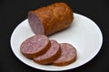 Delicious meat sausage on a white plate. Sliced ham. Slices of meat Royalty Free Stock Photo