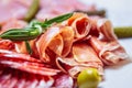 Delicious meat snacks for dinner.Sliced Spanish jamon,pepperoni sausages,beef ham served on plate in restaurant for snack.Gourmet Royalty Free Stock Photo