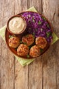 Delicious meatballs served with stewed red cabbage garnish and sauce close-up on the table. vertical top view Royalty Free Stock Photo