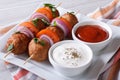 Delicious meatballs on skewers with sauce on a plate horizontal Royalty Free Stock Photo