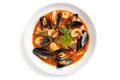 Delicious Mediterranean seafood soup with mussels and shrimp on a white background, top view