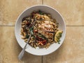 Delicious mediterranean style lunch - orzo with mushrooms, dried tomatoes, spinach and roasted chicken breast on a yellow stone Royalty Free Stock Photo