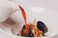 Delicious Mediterranean style tomato seafood soup with a variety of mixed seafood.